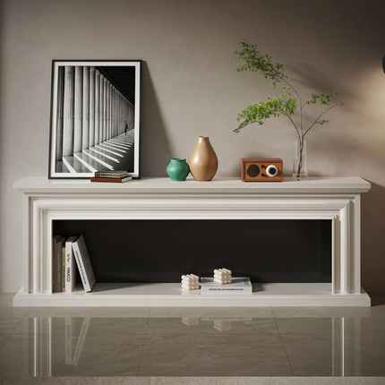 White fireplace mantle with decorative items including a framed picture, vase, and small radio.