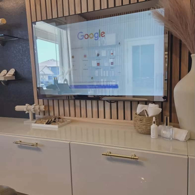 Smart TV displaying a Google screen on a white cabinet with decorative items.
