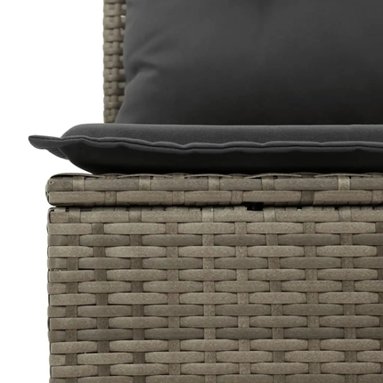Woven outdoor furniture with dark cushions on a white background