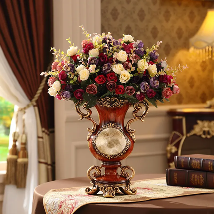 Decorative vase with a bouquet of flowers on a table in a room with curtains and a lamp.