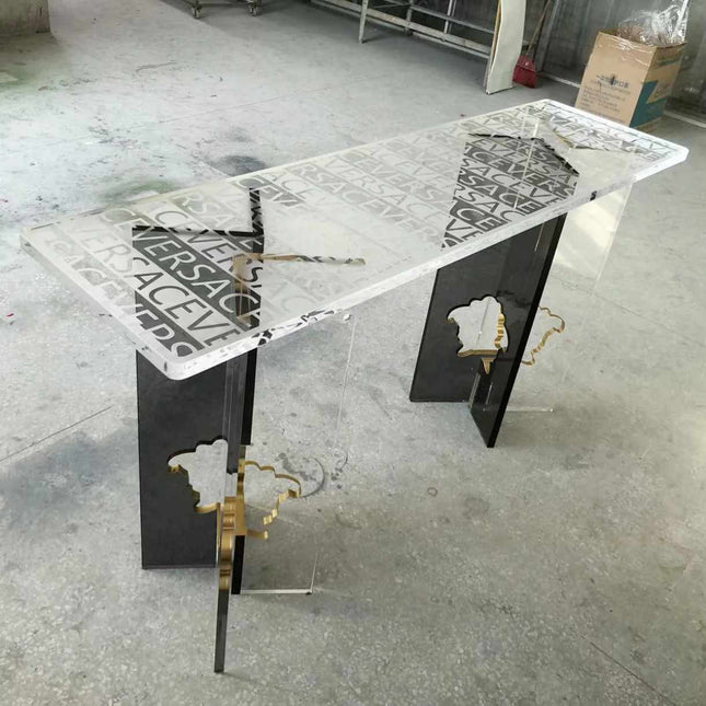 Versace Clear Surface Clarity Table Bold Typography Encased in Crystal Luxury and Contemporary Style Perfect for Elevating High-Fashion Flair  A Striking Centerpiece That Captures the Essence of Versace's Iconic Branding