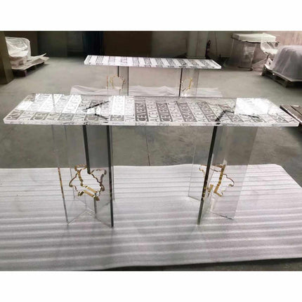 Versace Clear Surface Clarity Table Bold Typography Encased in Crystal Luxury and Contemporary Style Perfect for Elevating High-Fashion Flair  A Striking Centerpiece That Captures the Essence of Versace's Iconic Branding