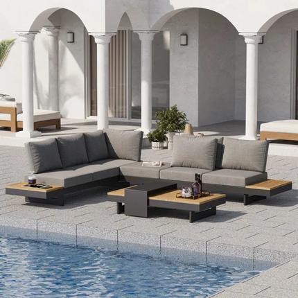 Outdoor patio furniture set by a pool with a modern architectural background