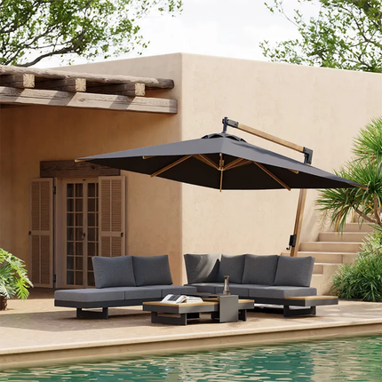 Outdoor patio set with sectional sofa and umbrella by a poolside.