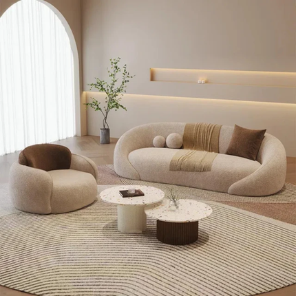 Modern living room with a beige sofa, armchair, and coffee table.