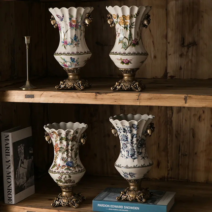Four ornate vases with floral patterns on a wooden shelf.
