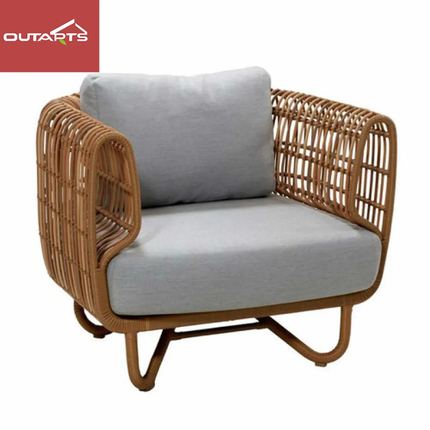Wicker armchair with gray cushions on a white background, featuring Outarts logo.