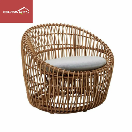 Wicker chair with a white cushion on a white background, featuring the Outarts logo.