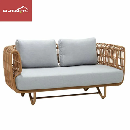 Wicker outdoor sofa with light gray cushions on a white background, featuring the Outartz brand.