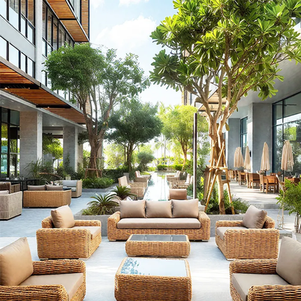 Outdoor patio area with wicker furniture and trees in an urban setting