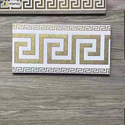 Box of Versace luxury tiles featuring a white and gold geometric pattern.