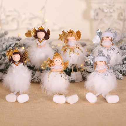 A set of white angel Christmas tree decorations with gold accents, positioned among artificial snow-covered branches and lights.