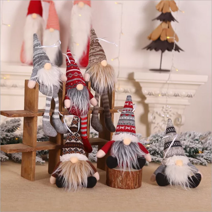 A set of decorative ELF dolls in various colors and patterns, seated on a wooden structure, with a festive background featuring Christmas lights and a Christmas tree.