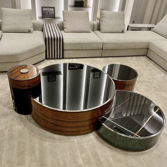 A stainless steel frame high gloss tempered glass coffee table with a wooden element, displayed in a modern living room setting.