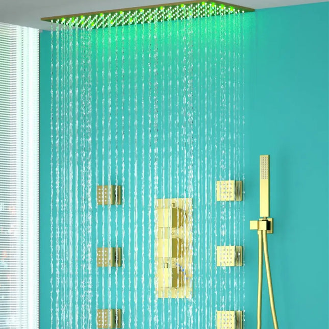 A brushed gold bathroom shower system with a rainfall shower head, LED lights in green and blue, and additional body jets installed on the wall.