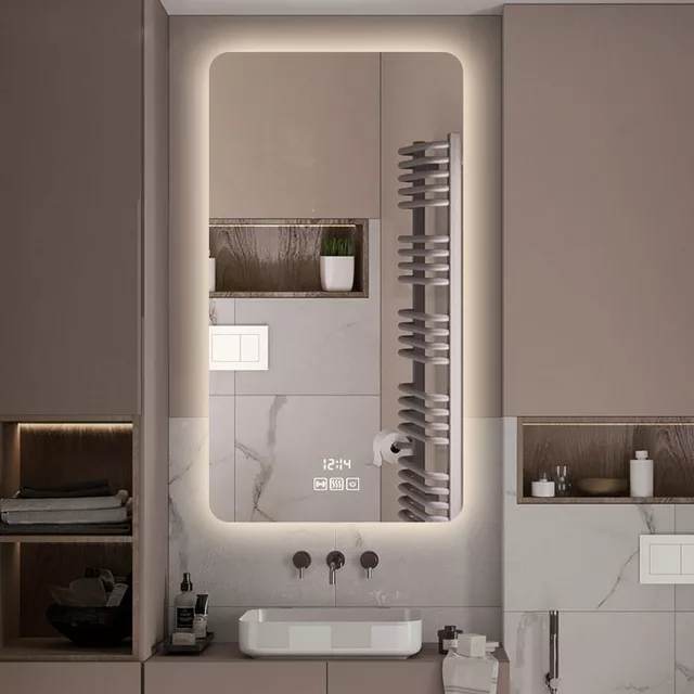 A wall-mounted illuminated smart LED mirror with a silver frame and multicolored LED lights, installed in a bathroom setting.