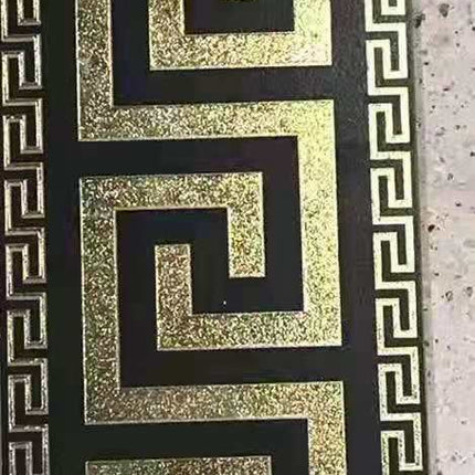 A set of Versace luxury black and gold tiles with a geometric pattern.