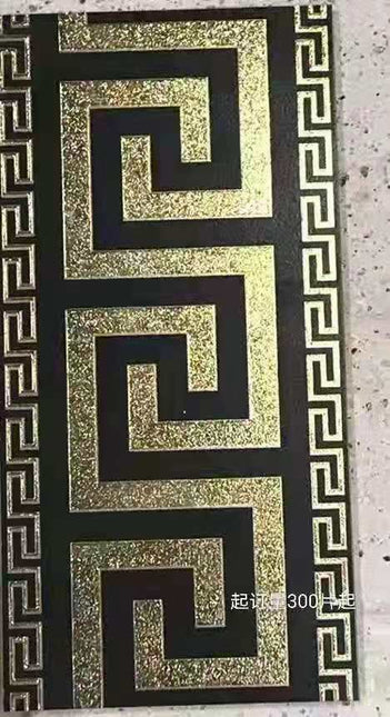A set of Versace luxury black and gold tiles with a geometric pattern.